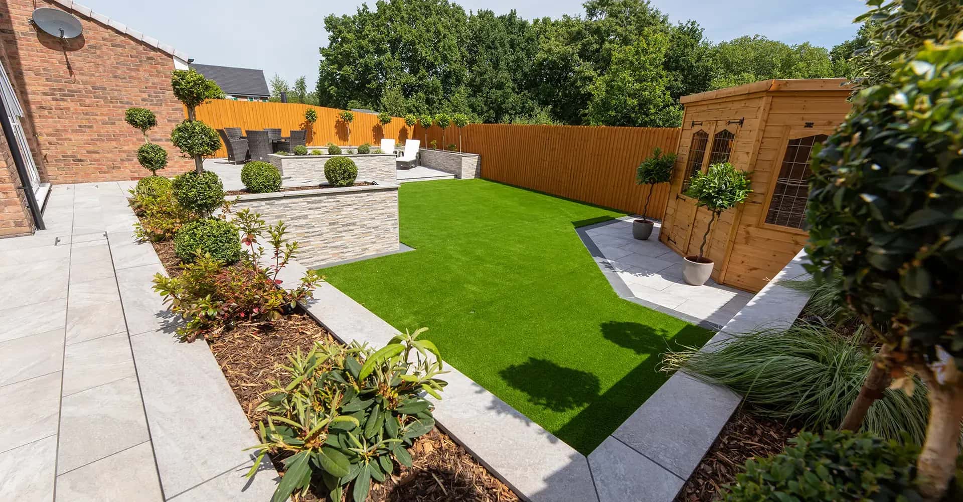 Beautiful garden landscape with lush green grass and professional landscaping