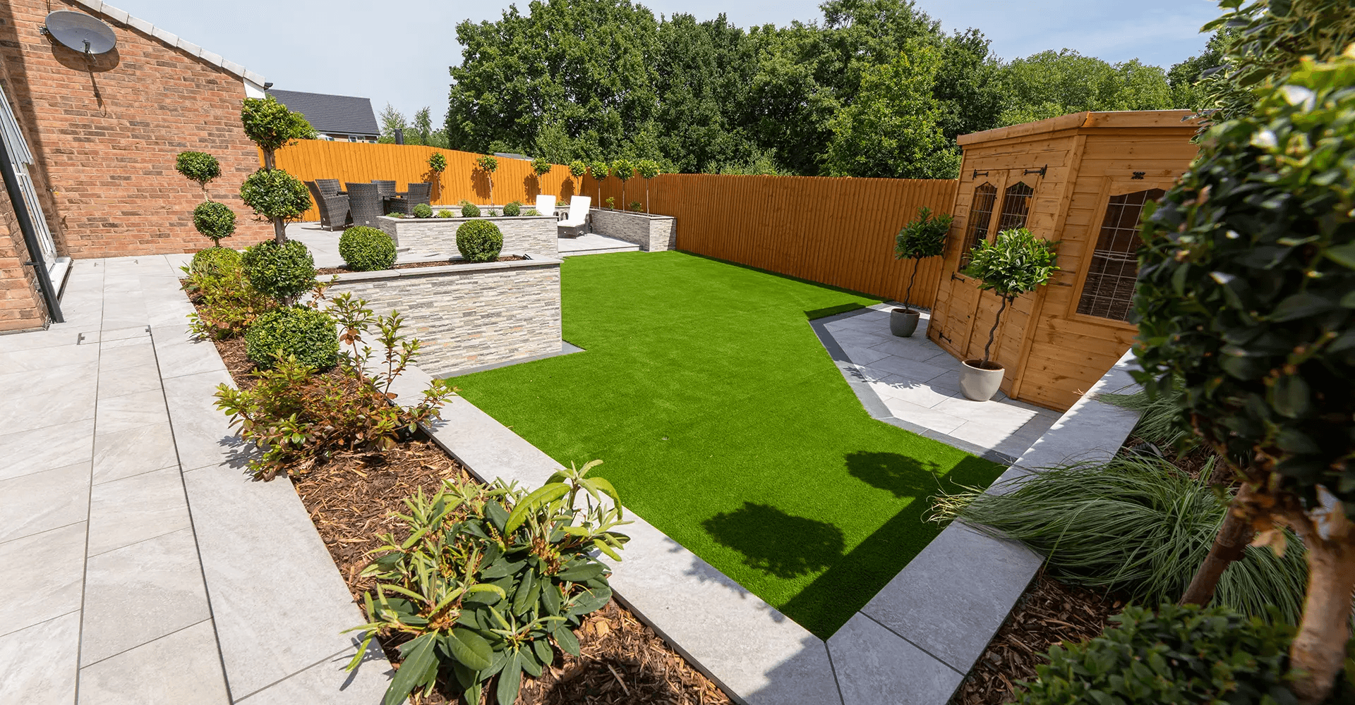 Beautiful garden landscape with lush green grass and professional landscaping